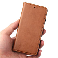 a person holding a cell phone in their hand