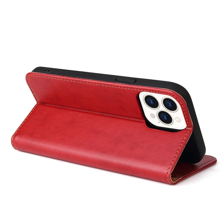 a red piece of luggage sitting on top of a table 