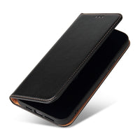 a black piece of luggage sitting on a white surface
