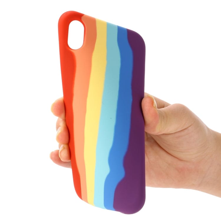 a person holding a colorful pair of scissors