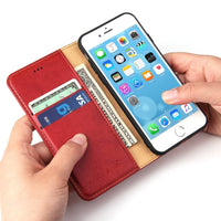 a person holding a cell phone in their hand 