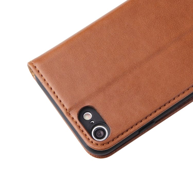 a cell phone sitting on top of a piece of luggage 