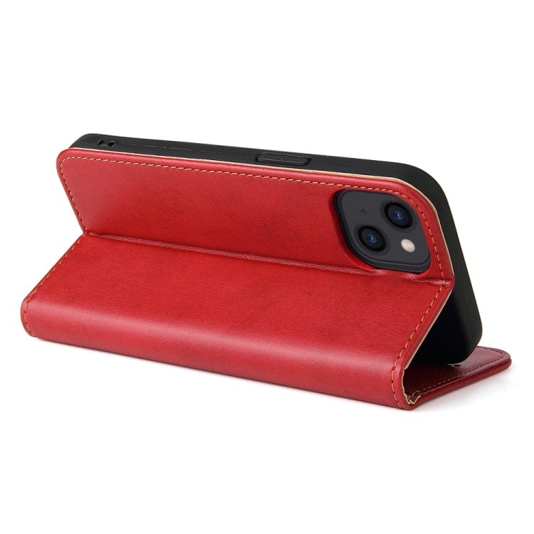 a red suitcase sitting on a white surface 