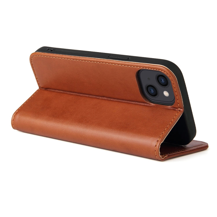 a brown suitcase sitting on a white surface 